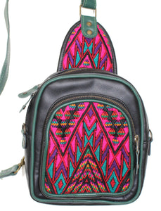 MoonLake Designs Blake Sling Over Backpack Bag in black and green handcrafted leather with fun beautiful mayan huipil design in pink green and black with green leather adjustable strap and accents and multiple easy access pockets perfect for concerts or traveling
