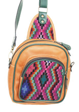 Load image into Gallery viewer, MoonLake Designs Blake Sling Over Backpack Bag in pear tan handcrafted leather with unique huipil design in pinks teal blue and orange with dark green leather adjustable strap and accents and multiple easy access pockets perfect for concerts or traveling