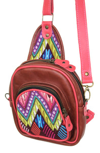 MoonLake Designs Blake Sling Over Backpack Bag in medium tan leather with fun mayan huipil design in pink green orange and red with purple leather adjustable strap and accents and multiple easy access pockets perfect for concerts or traveling