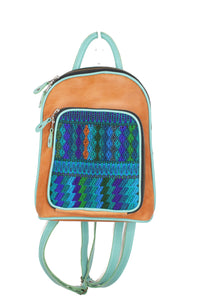 Petite small cute backpack purse in pear leather and teal leather. It has double zipper openings. Front pocket has storage for pens and credit cards. Main compartment has two open pockets and a zipper pocket.