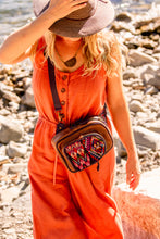 Load image into Gallery viewer, MoonLake Designs Blake sling over backpack worn by woman in coral pink jumpsuit on the shores of a lake