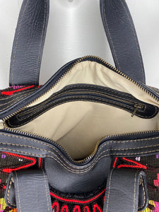 Close up of MoonLake Designs Elena Convertible Day Bag interior with cream lining, zippered pocket, and zippered bag closure 
