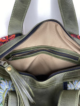 Load image into Gallery viewer, Close up of MoonLake Designs Elena Convertible Day Bag interior with beige lining, zippered pocket, and zippered bag closure with dark green leather tassel