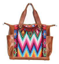 Load image into Gallery viewer, MoonLake Designs Gabriella large convertible day bag in medium tan leather with eye catching geometric handwoven huipil in vibrant green, blue, pink, orange, and yellow