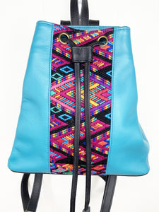 MoonLake Designs Maya bucket backpack in handcrafted electric blue leather close up view of geometric huipil design in black, electric blue, purple, yellow, and pink 