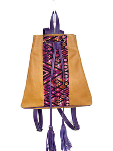 MoonLake Designs Maya bucket backpack in handcrafted pear tan leather with Mayan geometric huipil design and purple leather draw straps, backpack straps, and fringe ties