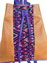 Load image into Gallery viewer, MoonLake Designs Maya bucket backpack in handcrafted pear tan leather close up view of huipil design in reds, pinks, purples, and tans. 