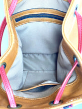 Load image into Gallery viewer, MoonLake Designs Maya bucket backpack inside view of pear leather, cream cloth interior, and zippered and open pockets