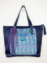 Load image into Gallery viewer, MoonLake Designs Olivia Large Tote Bag in textured navy blue handcrafted leather backview with mesmerizing floral huipil design in shades of blue, teal, and purple and leather tassel zipper closure with metal hardware – purple large fringe tassel sold separately