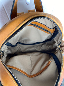 MoonLake Designs Paloma backpack inside view of cotton and leather interior showing back zippered compartment and open pockets and compartment zippered closure
