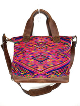 Load image into Gallery viewer, MoonLake Designs handmade Renata Medium Maleta Crossbody Bag in Dark Tan leather with handwoven huipil design featuring pinks, purples, oranges and more in a geometric panel