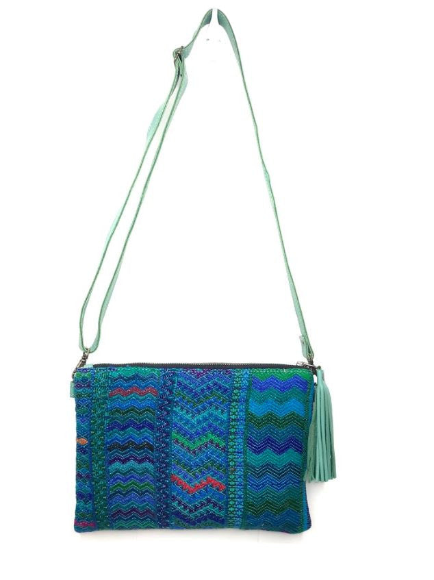 MoonLake Designs Lola small bag and clutch in teal leather with handwoven textile featuring different shades of blue and teal with teal leather tassel
